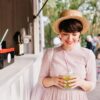 cheerful-girl-straw-hat-bought-cold-drink-walking-along-city-square